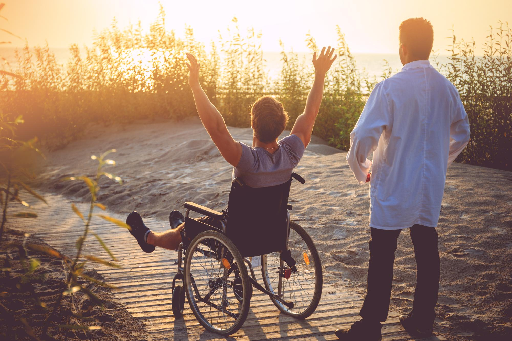 man-wheelchair-his-nurse-enjoying-sunrise-beach man-wheelchair-his-nurse-enjoying-sunrise-beach